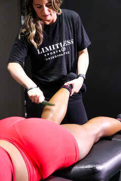 Graston Technique instrument-assisted soft tissue treatment being performed at Limitless Sports Chiropractic, the same manual therapy approach used to treat shoulder impingement and rotator cuff restrictions.
